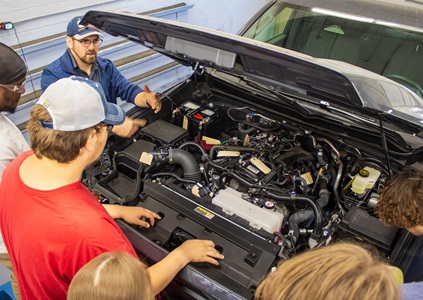 Aaron Hicks, instructor for automotive technology on the Searcy campus, helps students inspect and troubleshoot a vehicle’s mechanical issues.