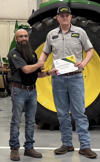 Jake Selvidge (left) congratulates Peyton Hobby, who received a $1,000 John Deere scholarship, sponsored by Greenway Equipment in Stuttgart.