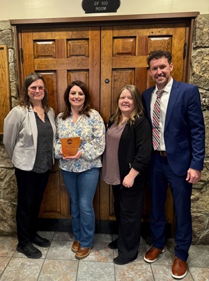 Amber Tillman accepts the Partner in Tourism award for Bank of Cave City from Cathy Drew, Crystal Crow and Adam Davis