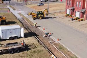 Construction Workers Lay Asphalt For Sidewalk Gap Fill In Fort Smith, Arkansas