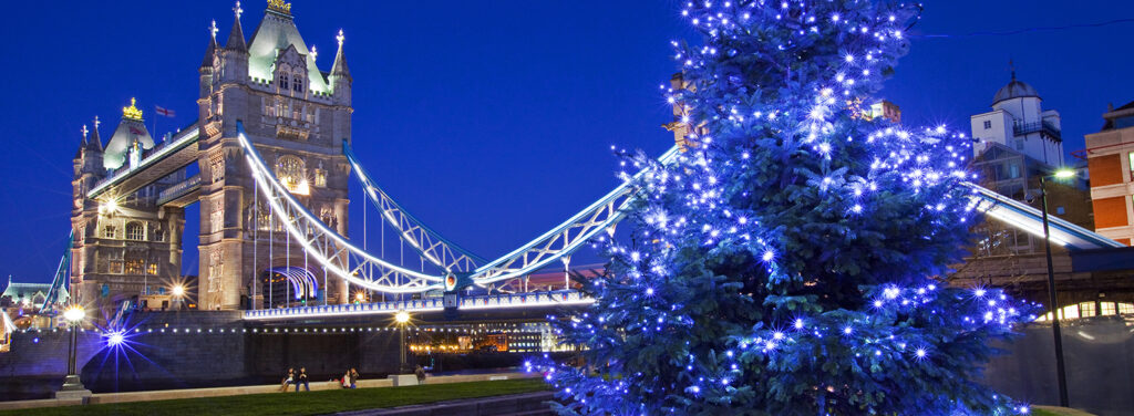 Christmas tree glowing with blue lights near Tower Bridge in London