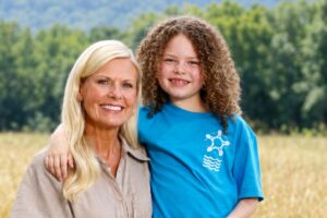 Woman and girl smiling in an Arkansas field