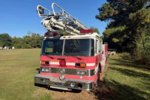 A retired Pierce fire truck with a Telesqurt ladder boom