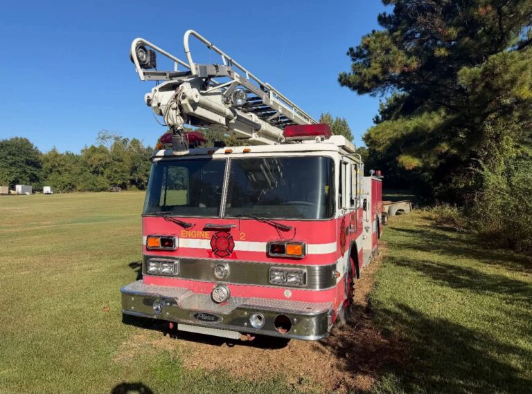 A retired Pierce fire truck with a Telesqurt ladder boom