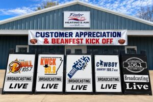 ArkansasRadio.com station Broadcasting Live signs in front of Foster Heating & Air in Mountain View Arkansas