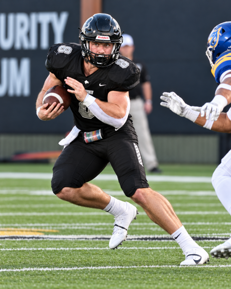 Harding University running back Andrew Miller carries the football