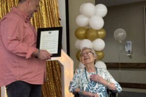 Searcy Mayor Mat Faulkner presents a proclamation to Imogene Howerton at her 100th birthday celebration in Searcy Arkansas