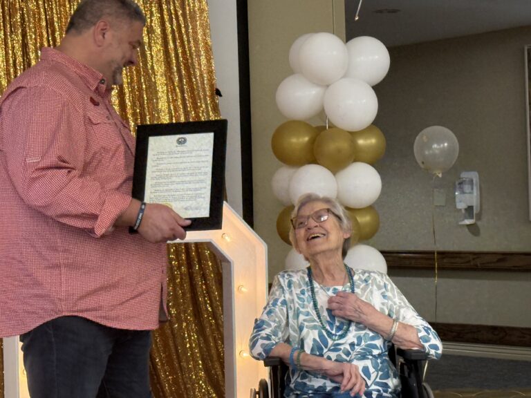 Searcy Mayor Mat Faulkner presents a proclamation to Imogene Howerton at her 100th birthday celebration in Searcy Arkansas