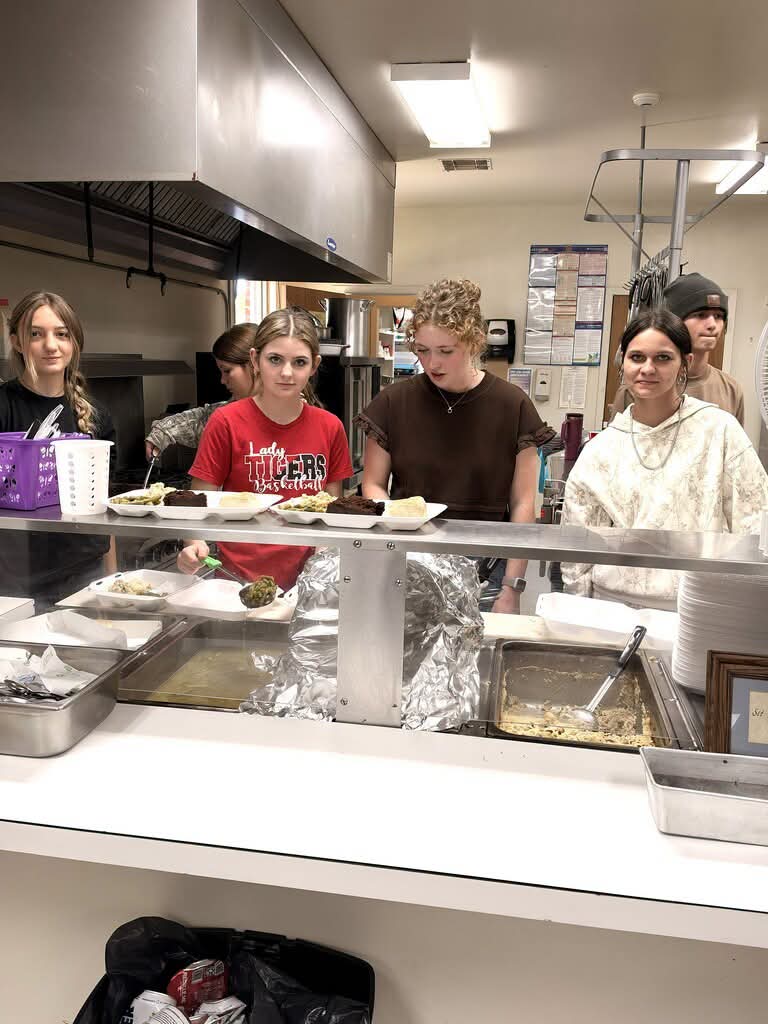 Pangburn FBLA students plating meals on the serving line at the Pangburn Senior Citizen Center